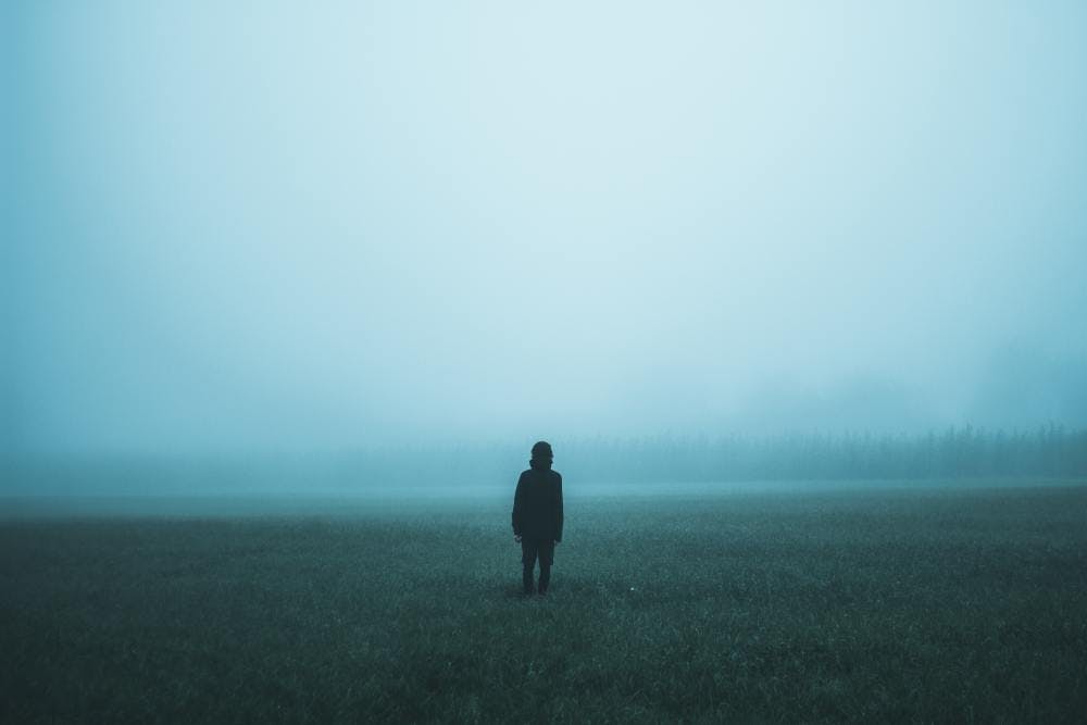 Someone standing in front of a cloudy background